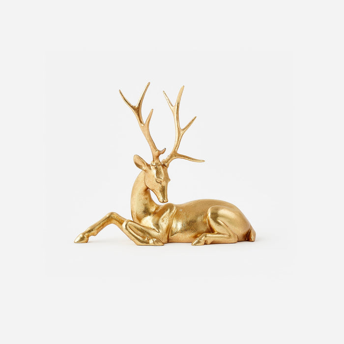 Gold deer figurine on a white background